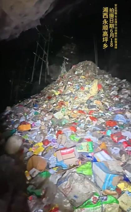湖南永顺一溶洞垃圾堆积如山?拍摄者:目测有15米高 当地称已在处置垃圾
